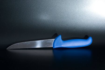 not-so-clean kitchen knife with blue handleの写真素材