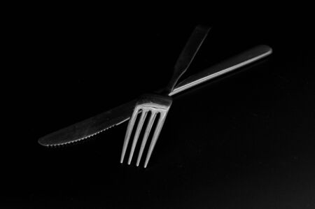knife and fork isolated on blackの写真素材