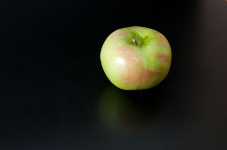  green apple with slightly  red colouring isolated on blackの写真素材