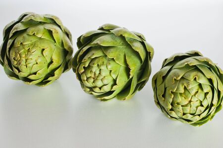 three artichokes in a rowの写真素材