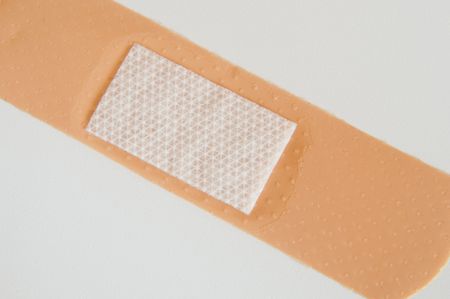 close up of a plaster as a symbol of first aid の写真素材