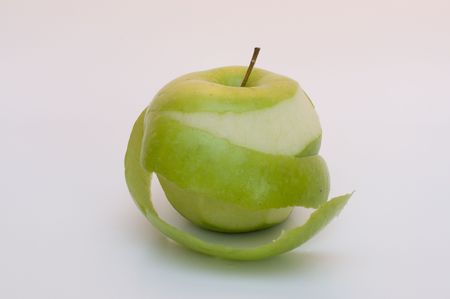 partially peeled green apple isolatedの写真素材