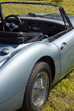 Classic british roadster in blue-gray with spoke rims