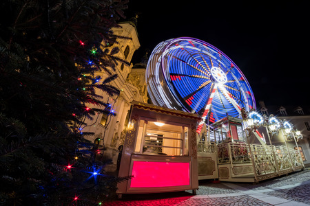 Ferris wheel on christmas fair on Mariahilferplatz in Graz with church Mariahilfの写真素材