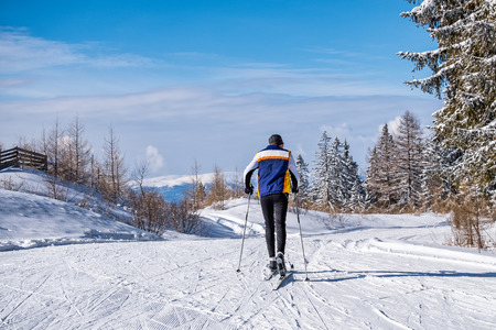 Man during cross-country skiing in the mountains of Hebalm in a sunny winter wonderland in Styria/Carinthia in Austriaの写真素材