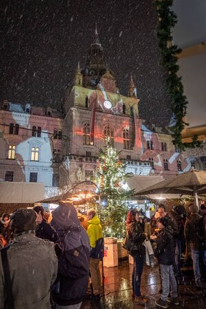 Snowfall on Christmas market Christkindlmarkt on main square with city hall Rathaus in Graz, Styria, Austriaのeditorial素材