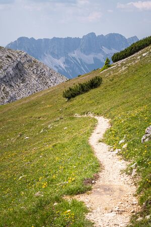 View from mountain Hochobir in Carinthia, Austria with hiking path to Karawanks on Border to Slovenia on a sunny summer dayの写真素材