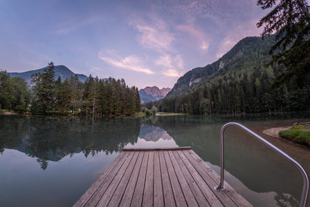 Landing stage on lake PlanÅ¡arsko jezero in Zgornje Jezersko with reflecting Kamnik-Savinja Alps...