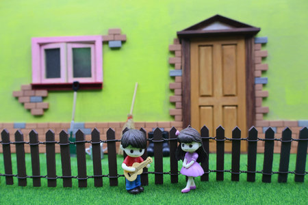 Cute little girl and boy in front of a colorful house.