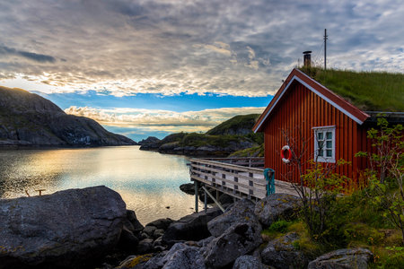 Sunrise in Nusfjord village, Norway. Nusfjord is one of the oldest and best preserved fishermen village of Lofoten islands. Currently is not inhabited permanently but rather a museum.のeditorial素材