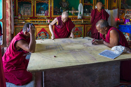 Diskit, India - August 20, 2015: Buddhist monks working on a mandala in monastery prayer hall. A mandala is a spiritual and ritual symbol in Indian religions, representing the universeのeditorial素材