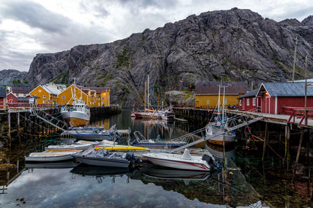 Nusfjord, Norway - August 20, 2016: View of the harbor under dramatic sky. Nusfjord is one of the oldest and best preserved fishermen village of Norway. It is located on the Lofoten Islandsのeditorial素材