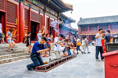 Beijing, China - August 18, 2011: Worshipers at the Yonghe Temple. Also known as the Lama Temple, is a monastery of the Gelug school of Tibetan Buddhism located in Dongcheng District, Beijing, Chinaのeditorial素材