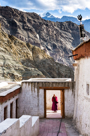 A Buddisth monk wait for visitors at the entrance of Rizong Monasteryのeditorial素材