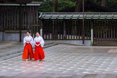 Tokyo, Japan - April 21, 2014: View of two Mikos in Meiji Shrine. In Shinto, a miko  is a shrine maiden or a supplementary priestess trained to perform sacred tasksのeditorial素材