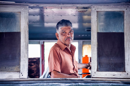 Kandy, Sri Lanka - August 19, 2017: A train driver inside locomotive at Kandy's station. Sri Lanka Railways (SRL) is the only rail transport organization in the countryのeditorial素材