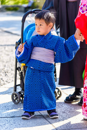 Kyoto, Japan - April 23, 2014: Little asian child with a blue kimono. The kimono is a traditional Japanese garmentのeditorial素材