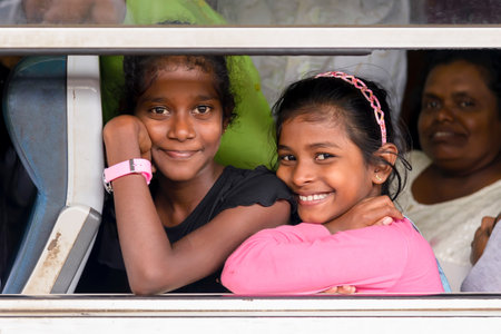 Kandy, Sri Lanka - August 19, 2017: Two smiling girls looking through window train at the Kandy's train stationのeditorial素材
