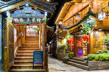 Lijiang, China - April 26, 2019: Traditional Naxi restaurants in Lijiang Old Town at night. Old town is an UNESCO World Heritage Site and combines traditional Nakhi culture with modern tourismのeditorial素材
