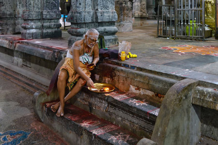 Kanchipuram, India - August 19, 2018: A brahmin walking to a hindu shrine inside the Ekambareswarar temple in Tamil Nadu stateのeditorial素材