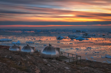 Sunset over Disko Bay, Greenland. It is the largest open bay in western Greenland, measuring 150 km...