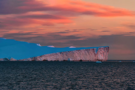 Sunset over an iceberg in the Icefjord, Greenland. Ilulissat Icefjord is a fjord in western Greenlandの写真素材