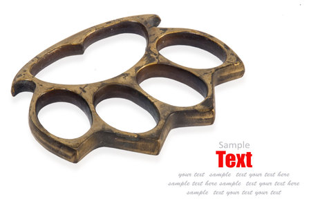 Photo of a pair of brass knuckles isolated on white 