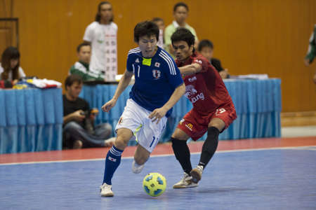 BANGKOK - DECEMBER 11 :, Unidentified players during a men's soccer match between Thailand vs Japan, Bangkok Futsal Super Match 2010.on DECEMBER 11 -12, 2010 in Bangkok, Thailand. のeditorial素材