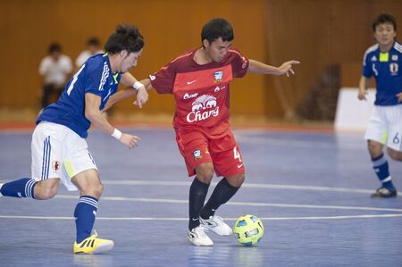 BANGKOK - DECEMBER 11 :, Unidentified players during a men's soccer match between Thailand vs Japan, Bangkok Futsal Super Match 2010.on DECEMBER 11 -12, 2010 in Bangkok, Thailand. のeditorial素材