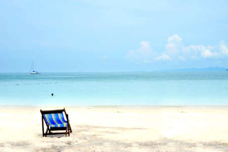 sun beach chairs on shore near seaの写真素材