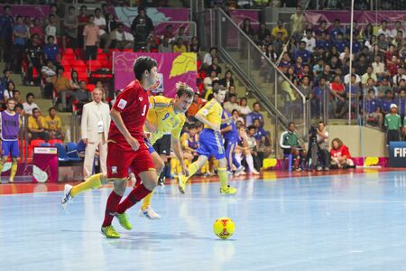 BANGKOK, THAILAND - NOV 04: Unidentified players in FIFA Futsal World Cup Group A match between Thailand (R) and Ukraine (Y) at Indoor Stadium Huamark on November 4, 2012 in Bangkok, Thailand. のeditorial素材