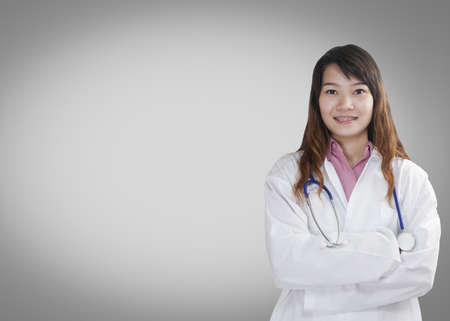 Portrait of a friendly female doctor isolated の写真素材