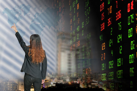 Portrait of smiling business woman   over stock exchange background の写真素材