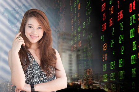 Portrait of smiling business woman . over stock exchange background の写真素材