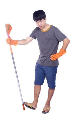Full length portrait of a male cleaner with a broom giving thumb up isolated on white background の写真素材