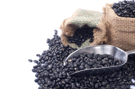 black beans in bag on white background の写真素材