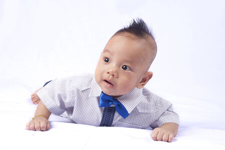 Portrait of a beautiful 6 months baby smiling, on white background の写真素材