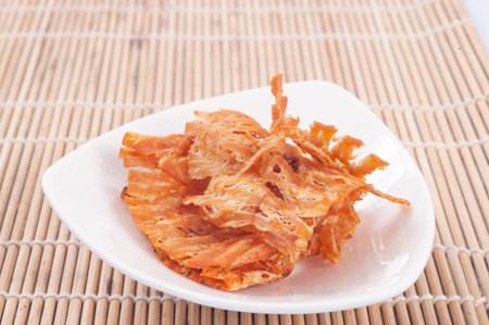 Sweet and spicy dried squid season on wooden