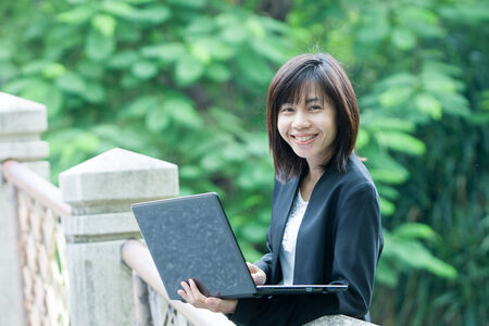 Business woman and laptop - isolated over a white backgroundの写真素材