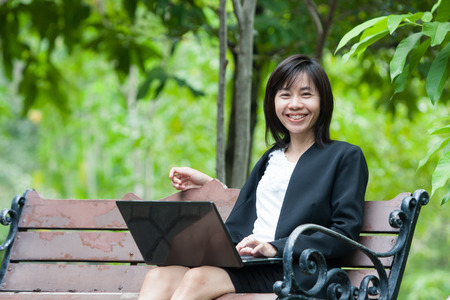 Business woman and laptop - isolated over a white backgroundの写真素材