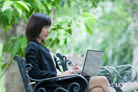 Business woman and laptop - isolated over a white backgroundの写真素材