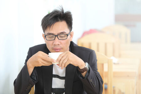 image of a asia businessman in a coffee shopの写真素材