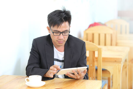 image of a asia businessman in a coffee shopの写真素材