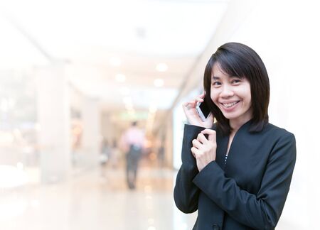 Portrait of young asia business woman 20 - 30 year old in her office.Mixed Asian / Caucasian businesswoman.Positive emotionの写真素材