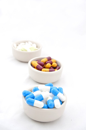 Tablets in the cup on white background.の写真素材