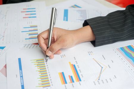 Businesswoman examine finance, tax, accounting, statistics and analytic research conceptの写真素材