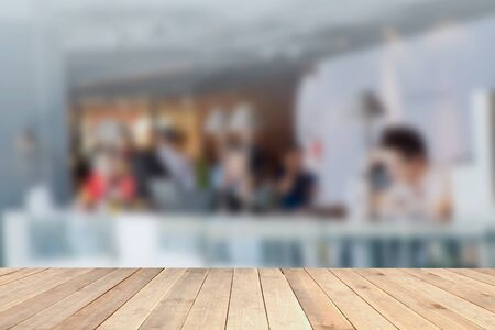 Wood table top with blurred office as background - can be used for montage or display your productsの写真素材