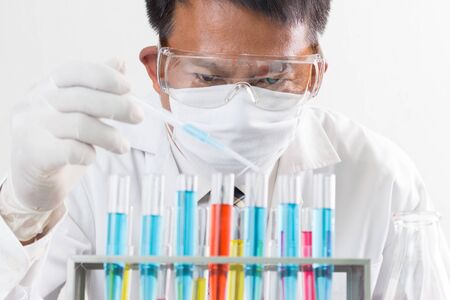liquid dripping from pipette into test tubeの写真素材