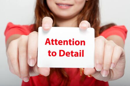 Businesswoman showing card with attention to detail message,の写真素材