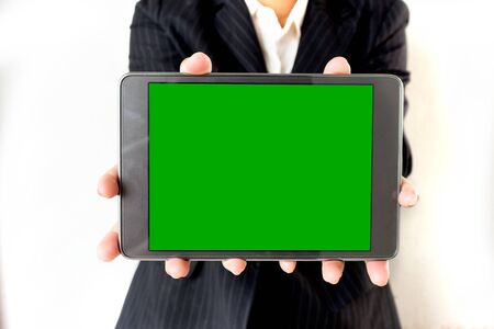 businesswoman hold green screen on Tabletの写真素材